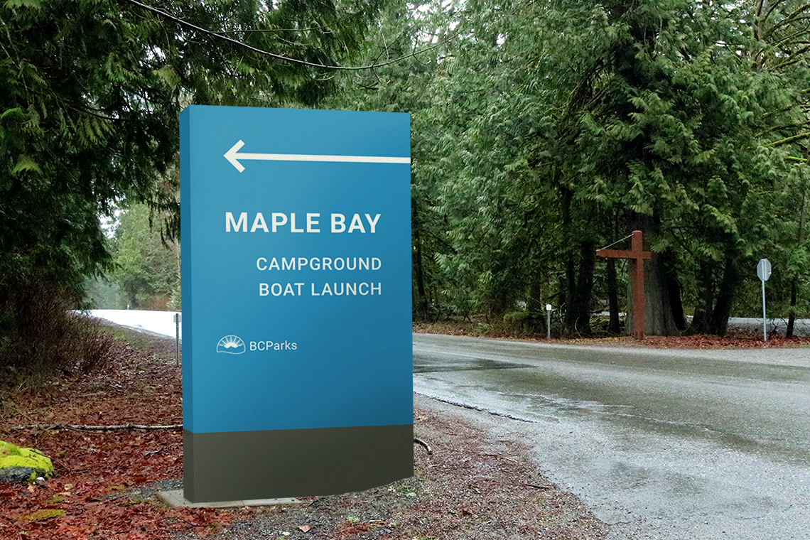 Sample mockup of the Maple Bay campground and boat launch signage next to the road